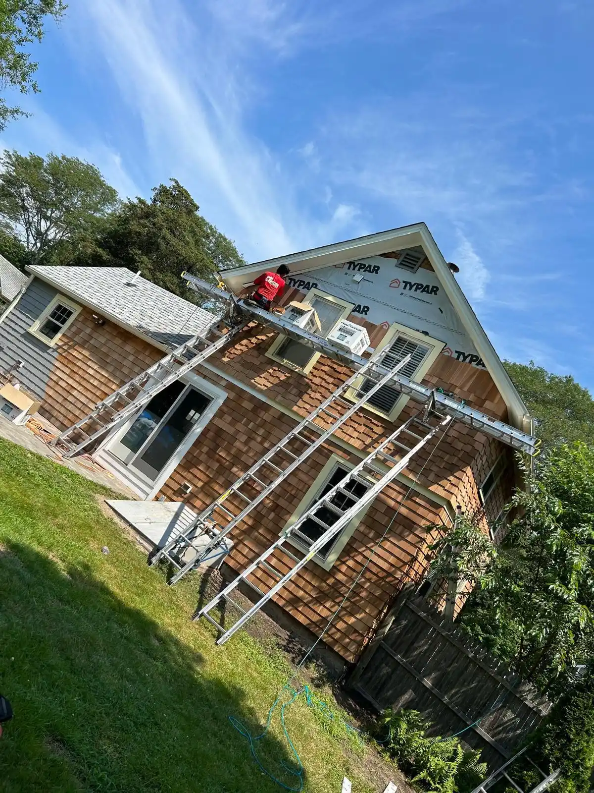 Cracked and warped siding panels on a Rhode Island home