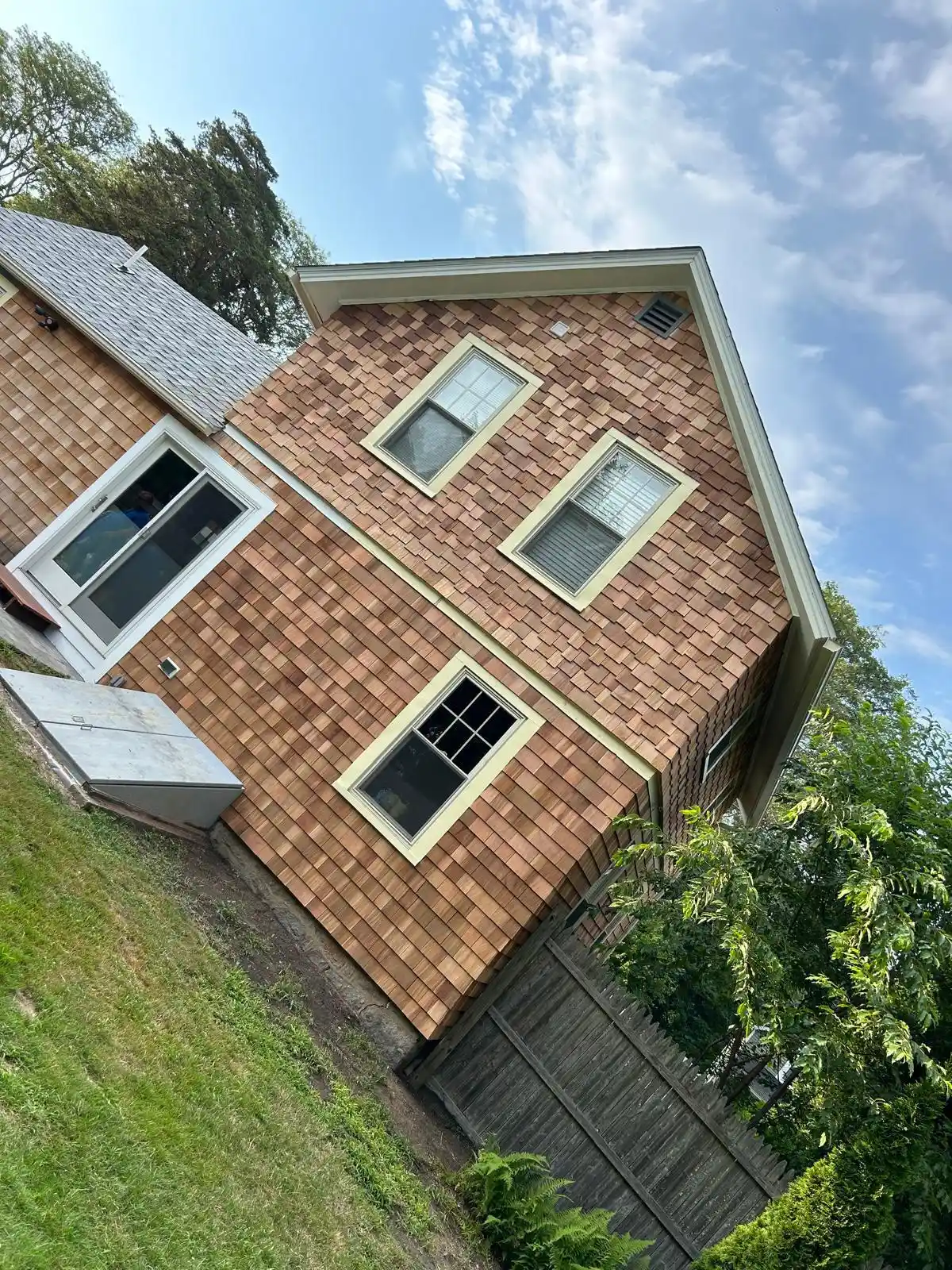 Siding crew working on a Rhode Island house exterior