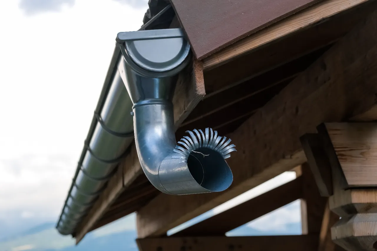 Exterior downspouts draining rainwater away from a building