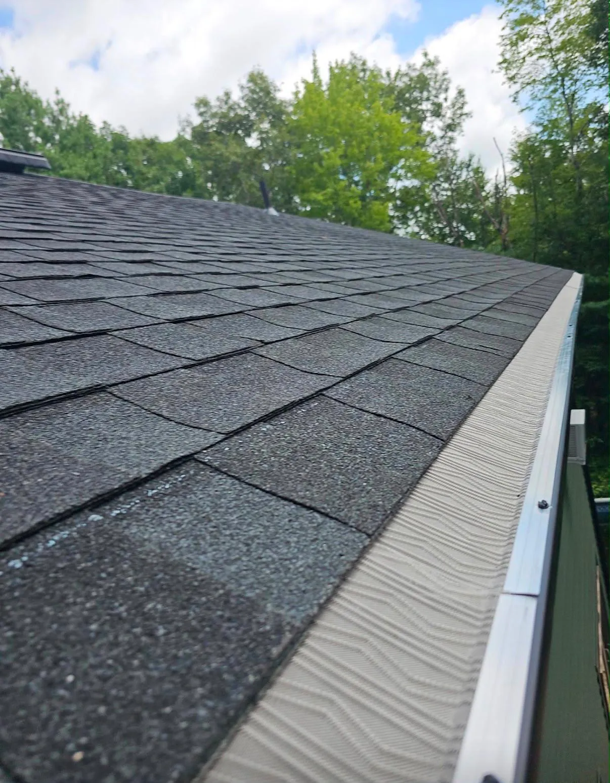 Gutter replacement along a Rhode Island roof edge