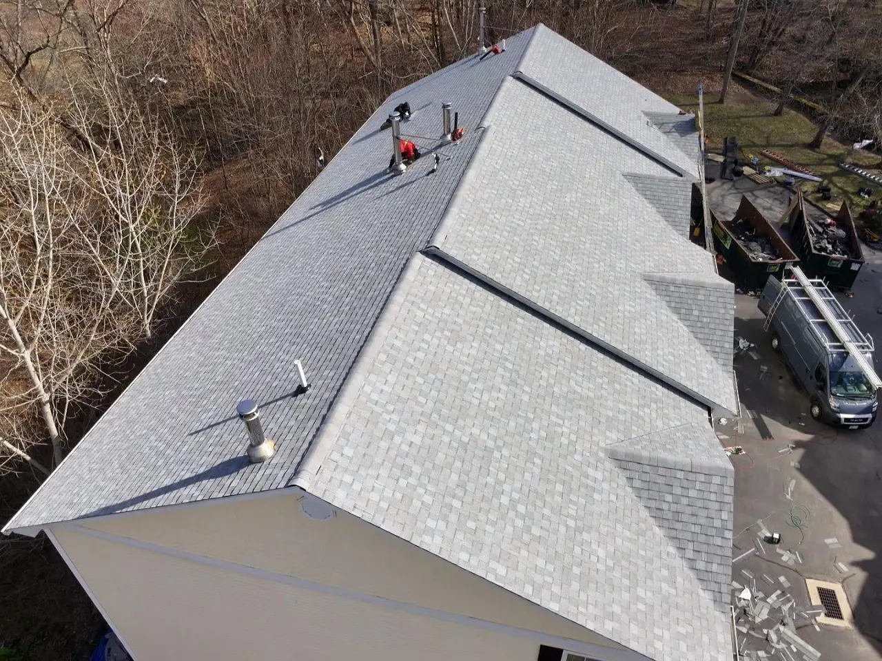 Roofing contractor installing a new shingle roof on a home in Rhode Island